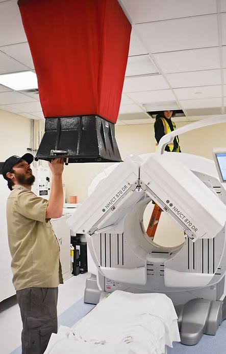 TAB Services technicians testing room pressure around medical imaging equipment
